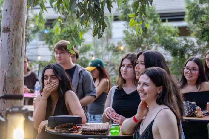 Audience members trying not to laugh during a serious moment on stage